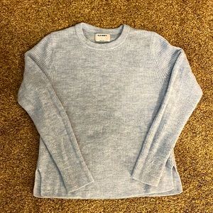Light blue sweater.